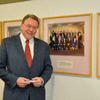 Don Brown in Macomb County Hallway with Picture of Board of Commissioners